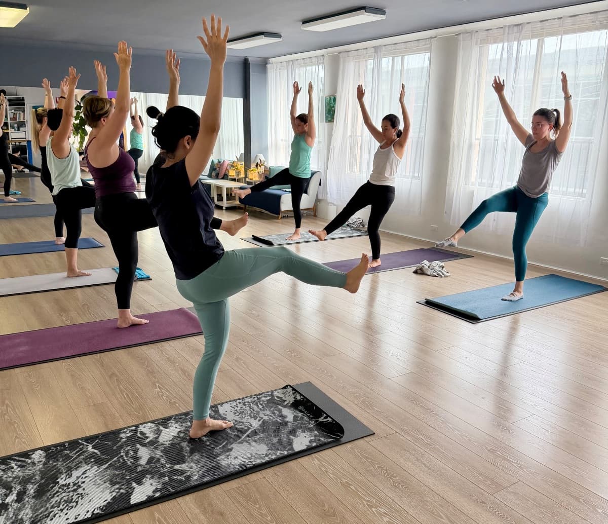 Yoga class in warrior pose at the Evolvere studio in Lane Cove