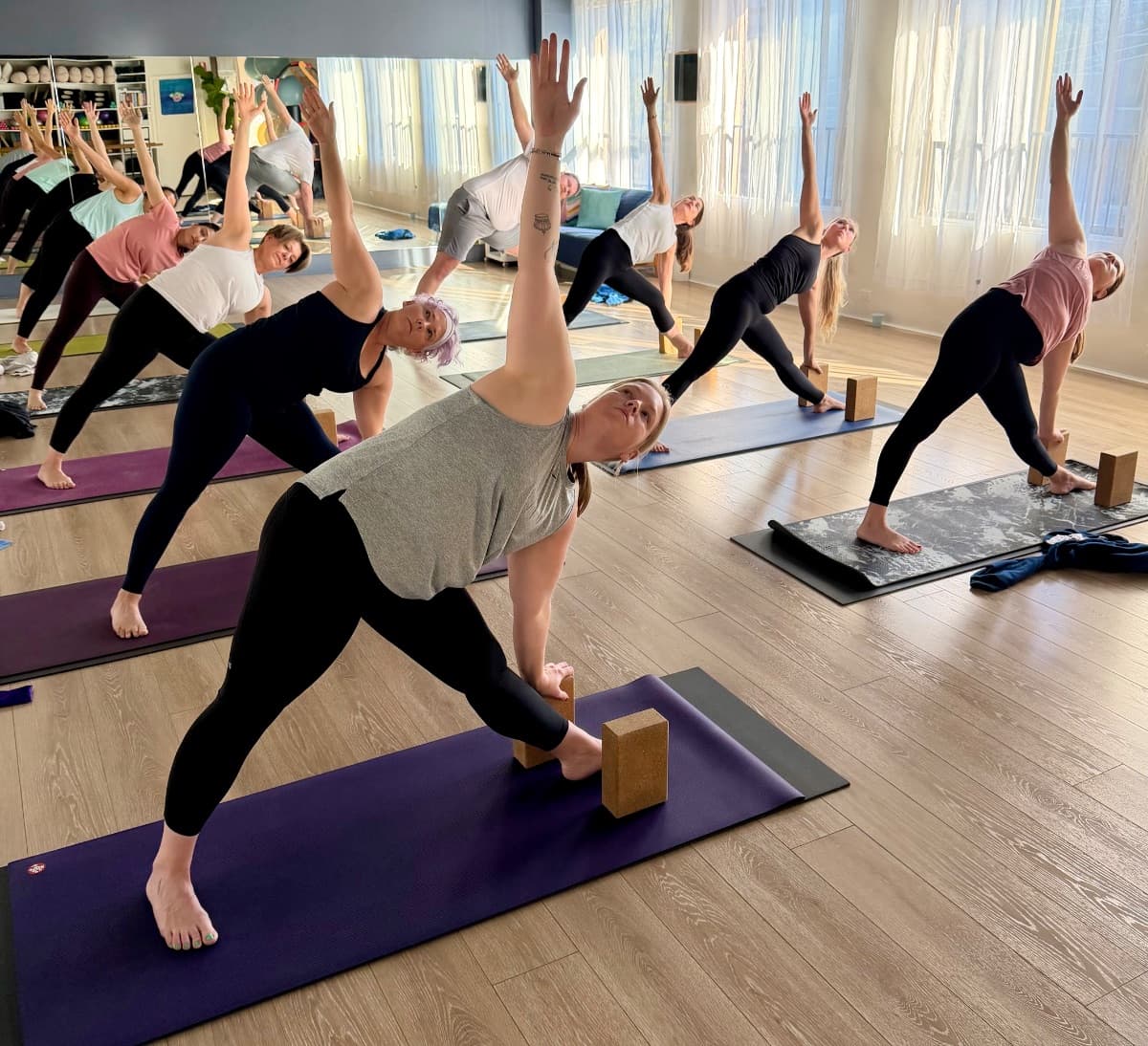 Triangle pose with blocks in a dynamic yoga flow class at Evolvere Lane Cove