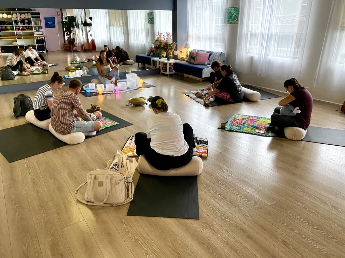 Parents and babies sitting together during a sound bath session in Sydney