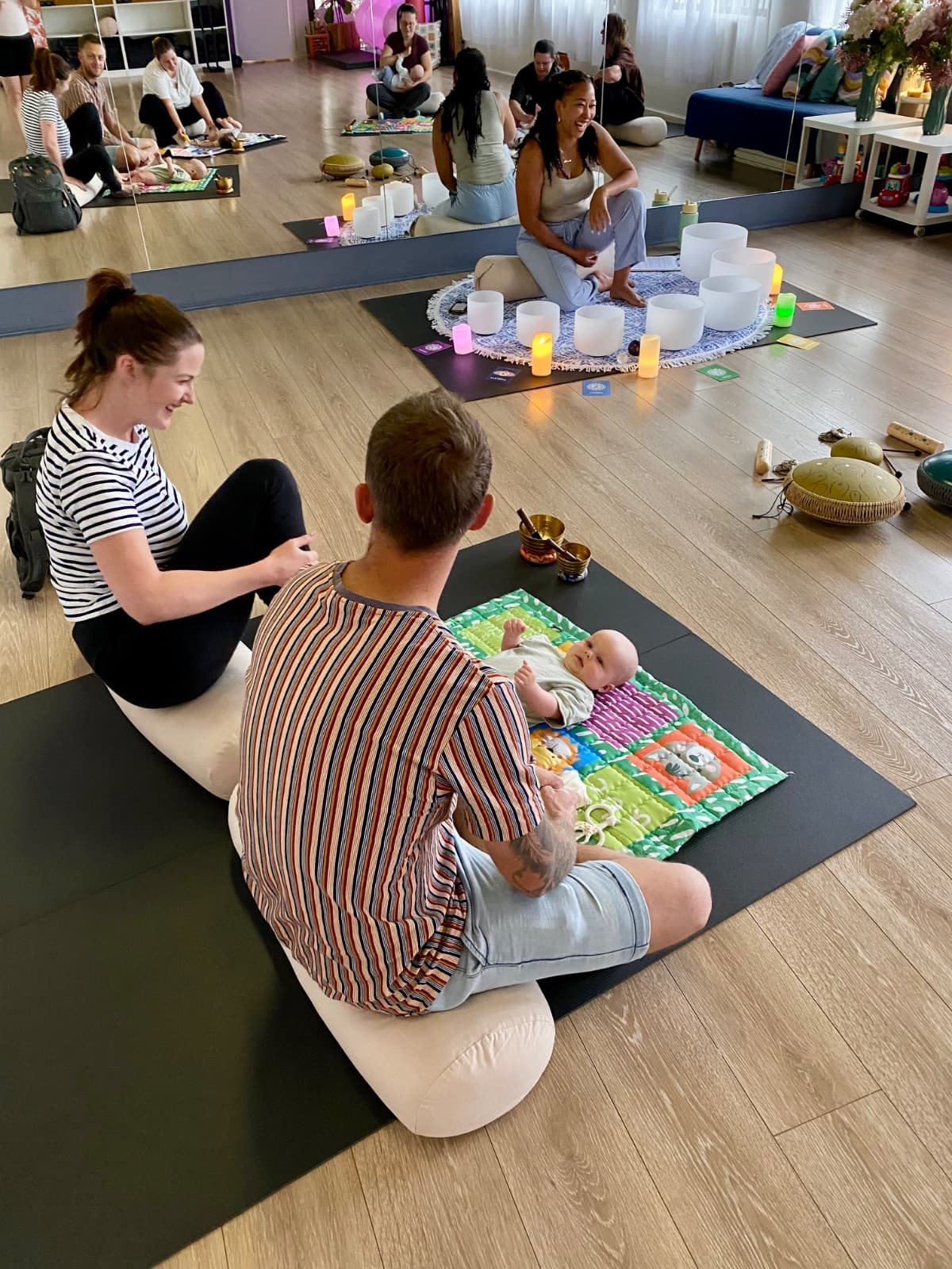 Family with baby enjoying crystal singing bowl sound healing at Evolvere